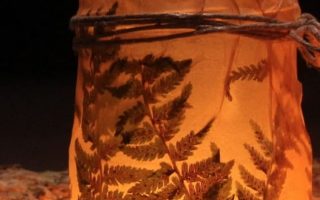 candles in brown decorative jars beside firewood Halloween 66