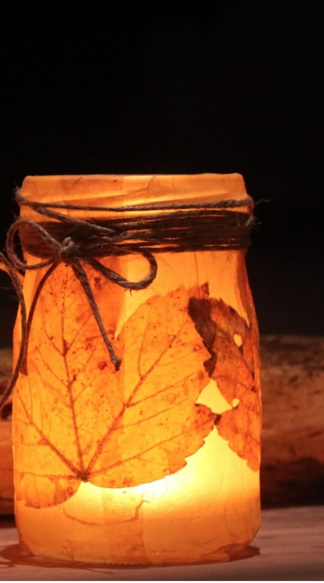 candles in brown decorative jars beside firewood Halloween 67