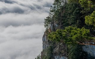 green trees on mountain under white clouds and blu iphone wallpaper