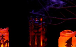 jack o lantern beside glass jar with candle autumn black 1 scaled
