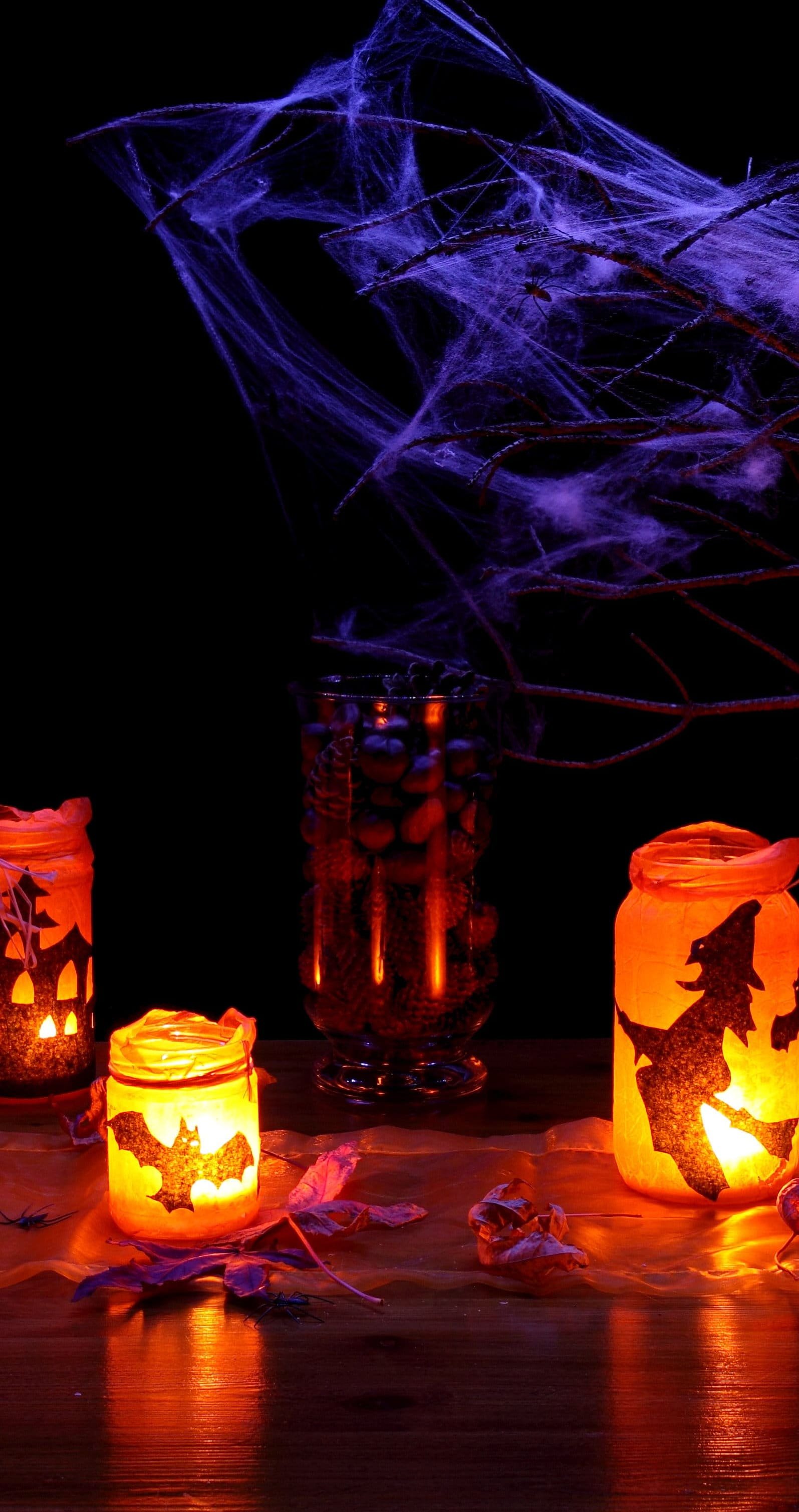 jack o lantern beside glass jar with candle, autumn, black